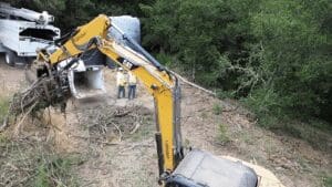 A yellow and black excavator is on the ground