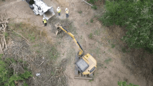 A crane is being used to move debris.